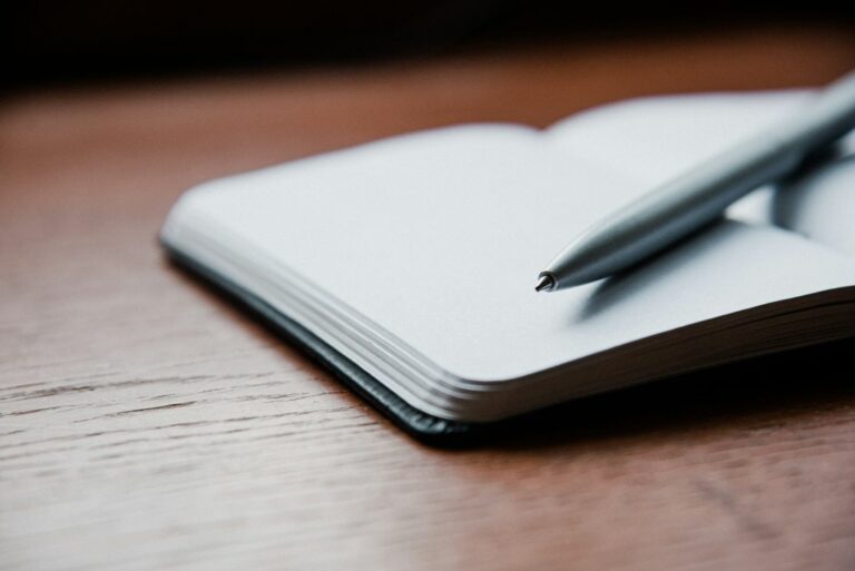 A notebook and pen arranged for writing, illustrating memories and poetry